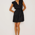 Woman wearing a black dress against a white background