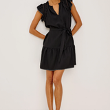 Woman wearing a black dress against a white background