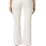 A person shown from the back wearing off-white cropped flare jeans with a white top and tan flat shoes, photographed against a plain white studio background.