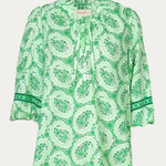 Green patterned blouse on a white background
