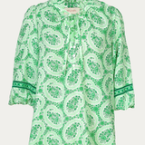 Green patterned blouse on a white background