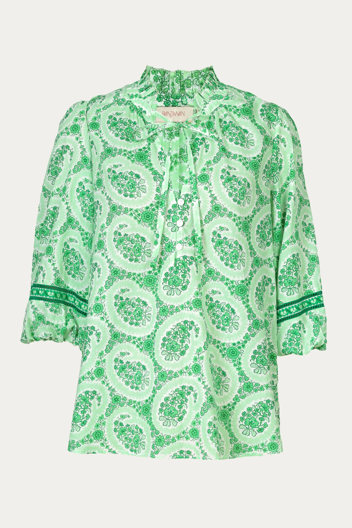 Green patterned blouse on a white background