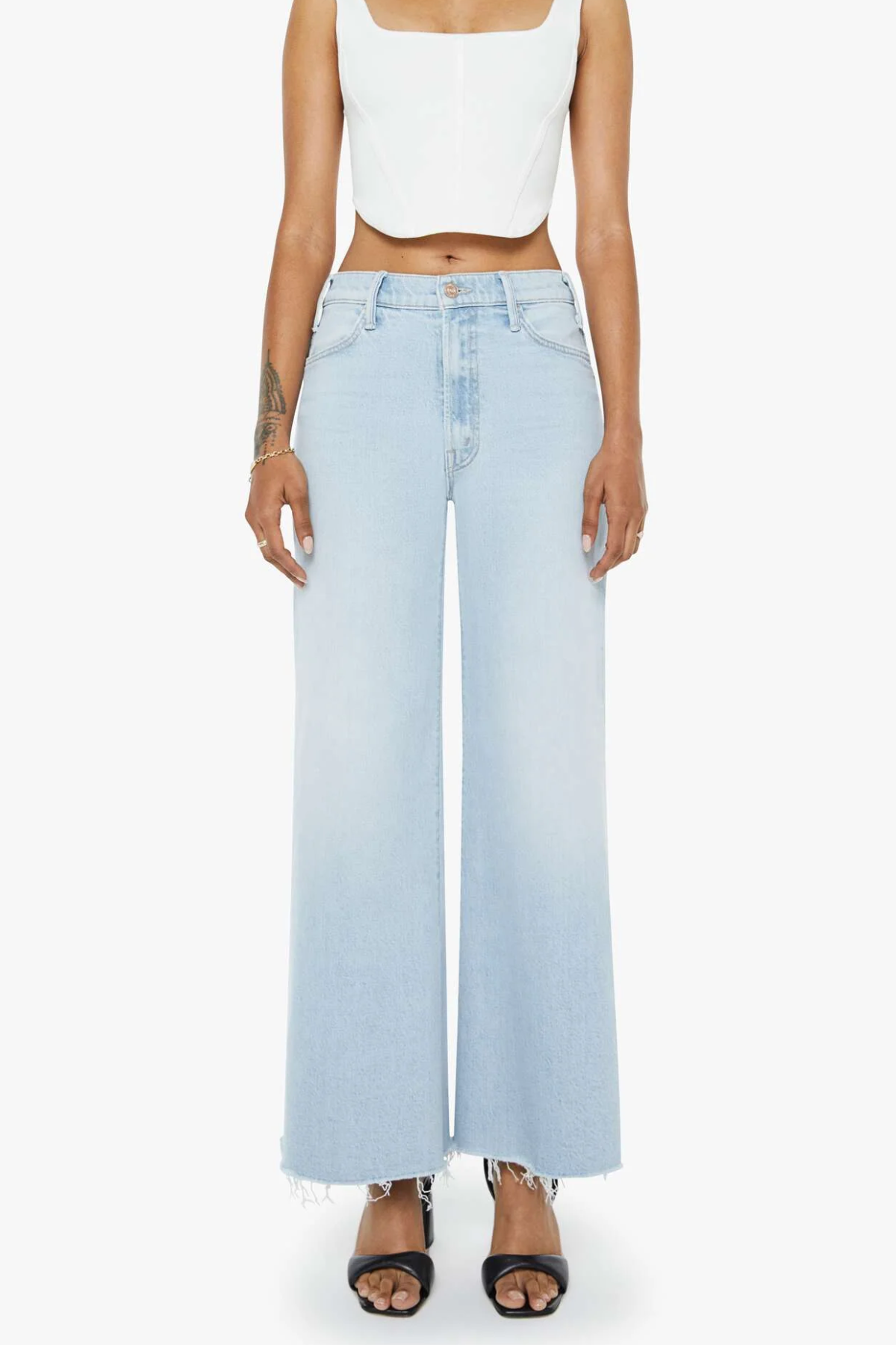 Light blue wide-leg jeans worn by a person on a white background