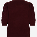 A dark burgundy knit sweater with three-quarter sleeves, featuring textured geometric cutout patterns on the upper sleeves, shown from the back against a light gray background.