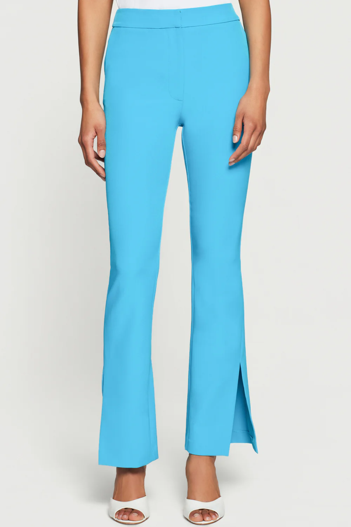 Blue pants worn by a person on a white background