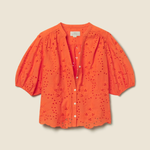 orange eyelet top on tan background 