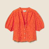 orange eyelet top on tan background 