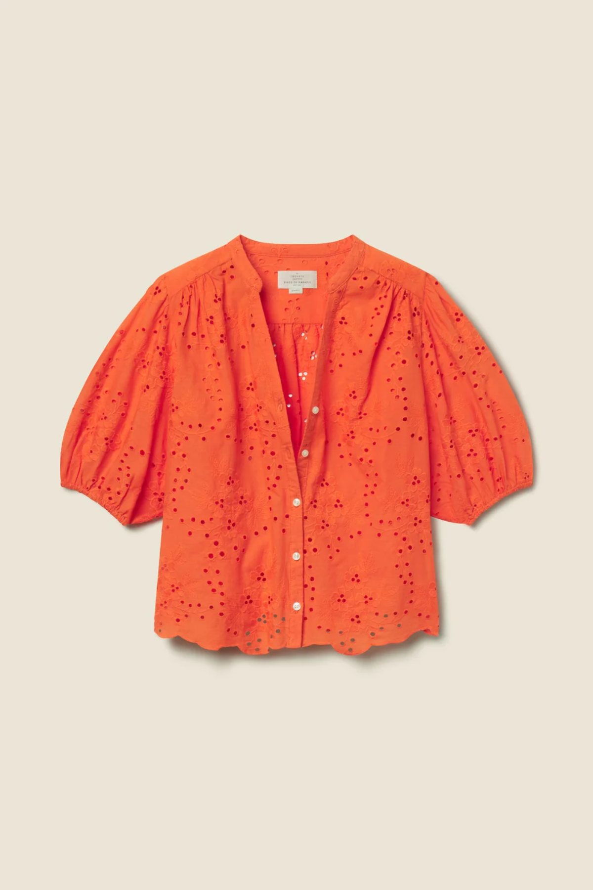 orange eyelet top on tan background 