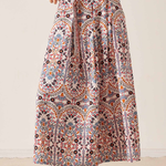 Women's printed midi skirt featuring a flowing silhouette and warm-toned geometric-inspired pattern.