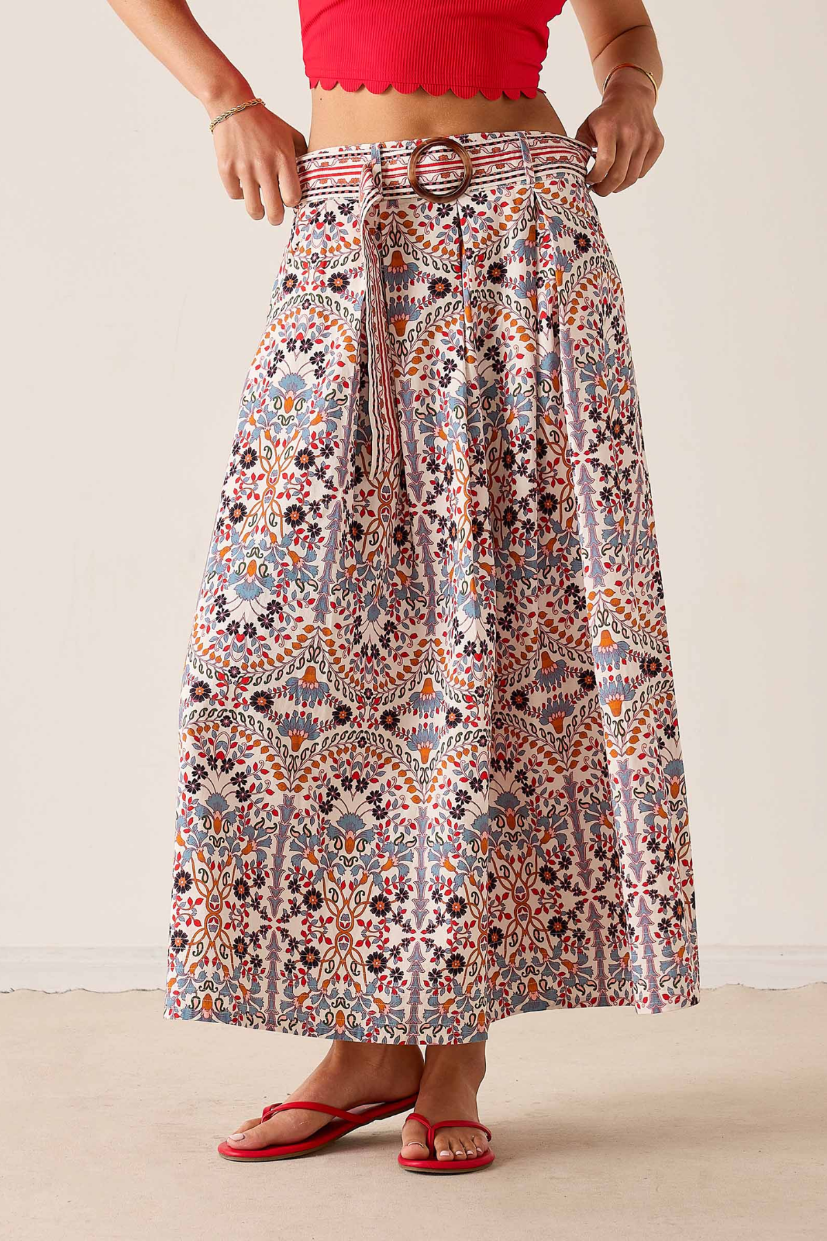 Women's printed midi skirt featuring a flowing silhouette and warm-toned geometric-inspired pattern.