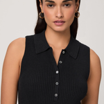 Woman wearing a black sleeveless ribbed top against a plain background