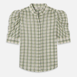 Model wearing a light green printed blouse with a relaxed silhouette