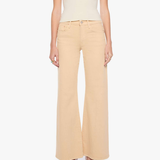 A model wearing a cream short-sleeve top and light beige wide-leg cropped pants with black pointed-toe heels, shown against a plain white studio background.