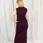 Coordinated burgundy pleated top and skirt set styled for a polished seasonal look