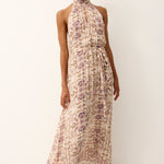 Woman wearing a floral dress against a white background