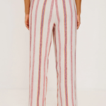 Person wearing a striped outfit with wide-leg pants on a white background