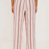 Person wearing a striped outfit with wide-leg pants on a white background