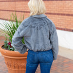 Faux fur zip-up jacket with a plush collar in a neutral tone
