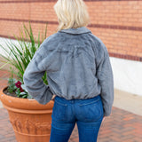 Faux fur zip-up jacket with a plush collar in a neutral tone