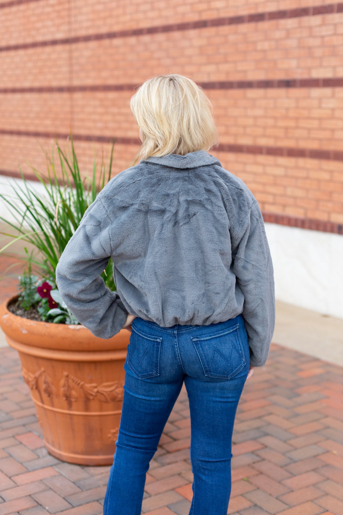 Faux fur zip-up jacket with a plush collar in a neutral tone