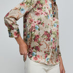Floral patterned shirt worn by a person on a plain background