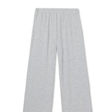 Woman wearing light grey knit pants with a straight leg silhouette, styled in soft studio lighting.