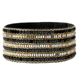 A wide black beaded wrap bracelet with alternating rows of gold chain and rows of black beads accented with iridescent rectangular crystals, shown on a plain white background.