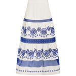 A white tiered skirt with blue floral and geometric embroidered patterns, shown against a plain white background.