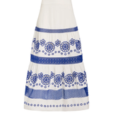 A white tiered skirt with blue floral and geometric embroidered patterns, shown against a plain white background.