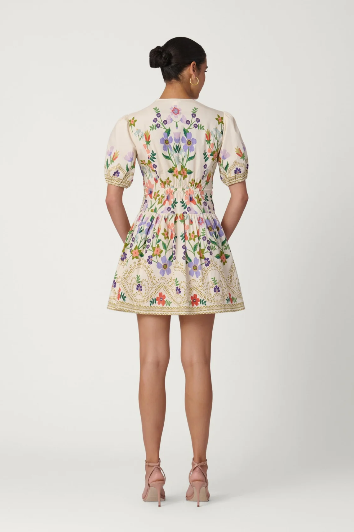 Woman wearing a floral dress on a white background
