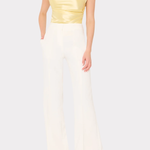 Woman wearing a yellow top and white pants on a white background