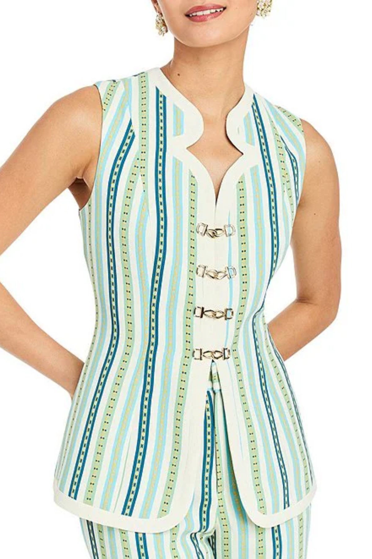 Woman wearing a sleeveless, striped top with decorative buttons on a white background