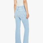 Light blue jeans worn by a person on a white background