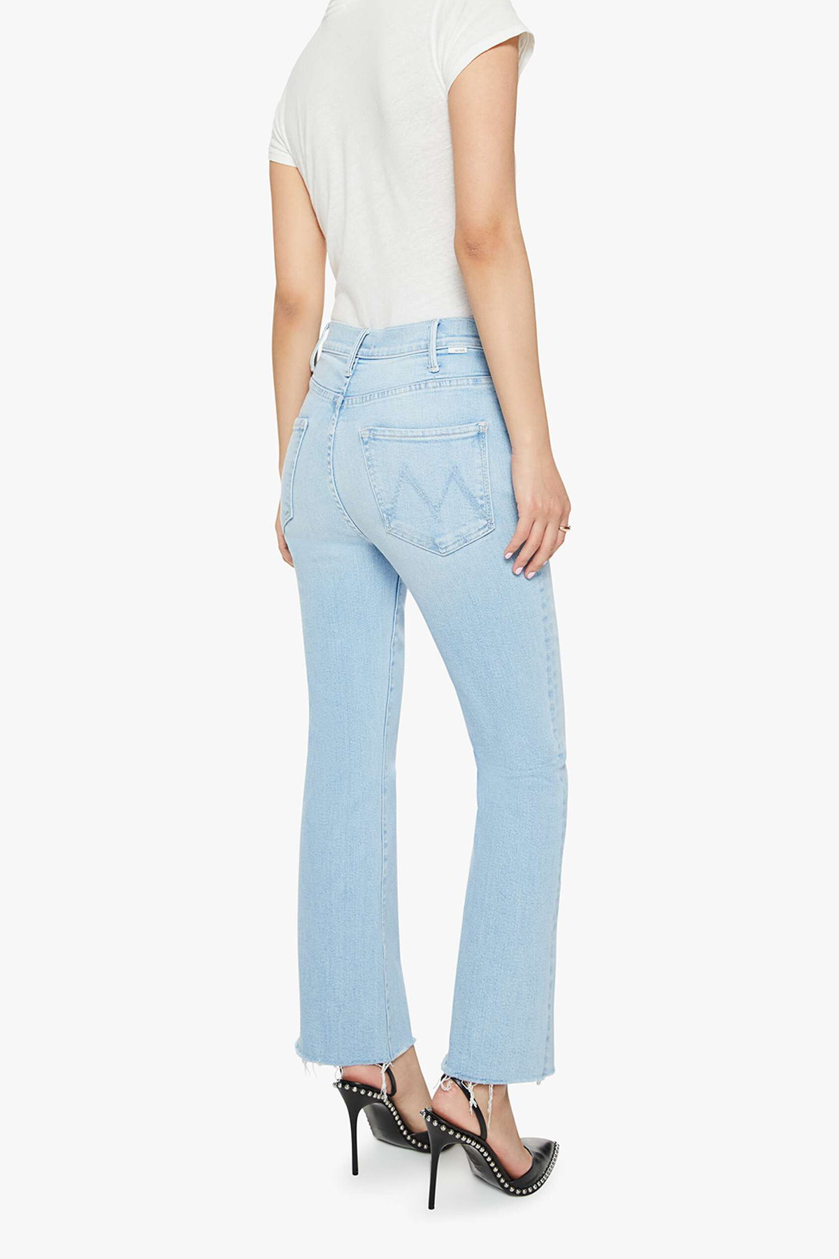 Light blue jeans worn by a person on a white background