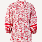 red printed long sleeve blouse on a white background