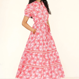 Woman wearing a pink floral dress on a white background