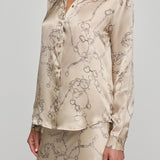 Beige floral patterned shirt and skirt set on a plain background