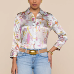 Woman wearing a floral blouse and jeans on a beige background