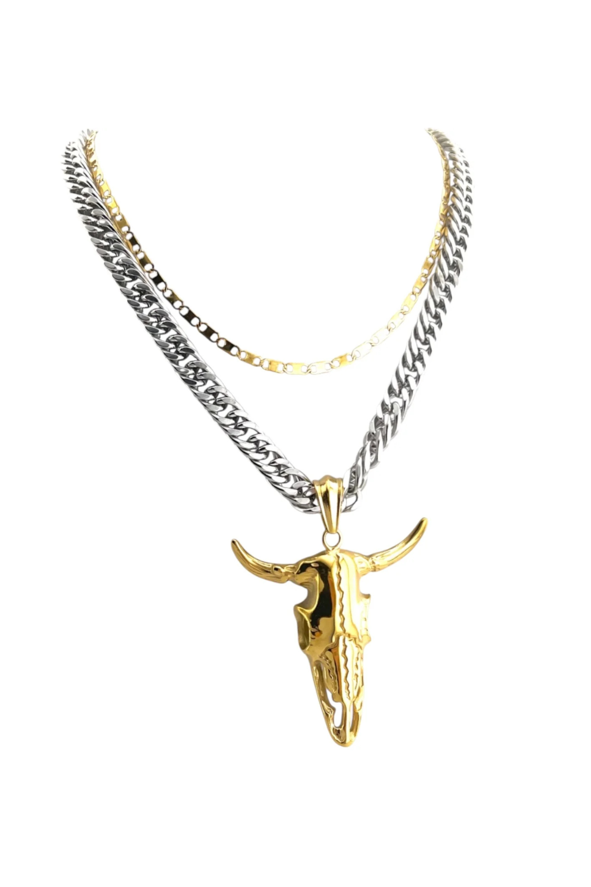 Gold bull skull pendant on a silver chain against a white background