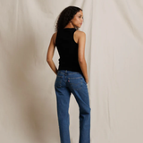 back of woman in black tank top and denim 