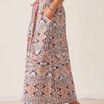 Women's printed midi skirt featuring a flowing silhouette and warm-toned geometric-inspired pattern.