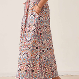 Women's printed midi skirt featuring a flowing silhouette and warm-toned geometric-inspired pattern.