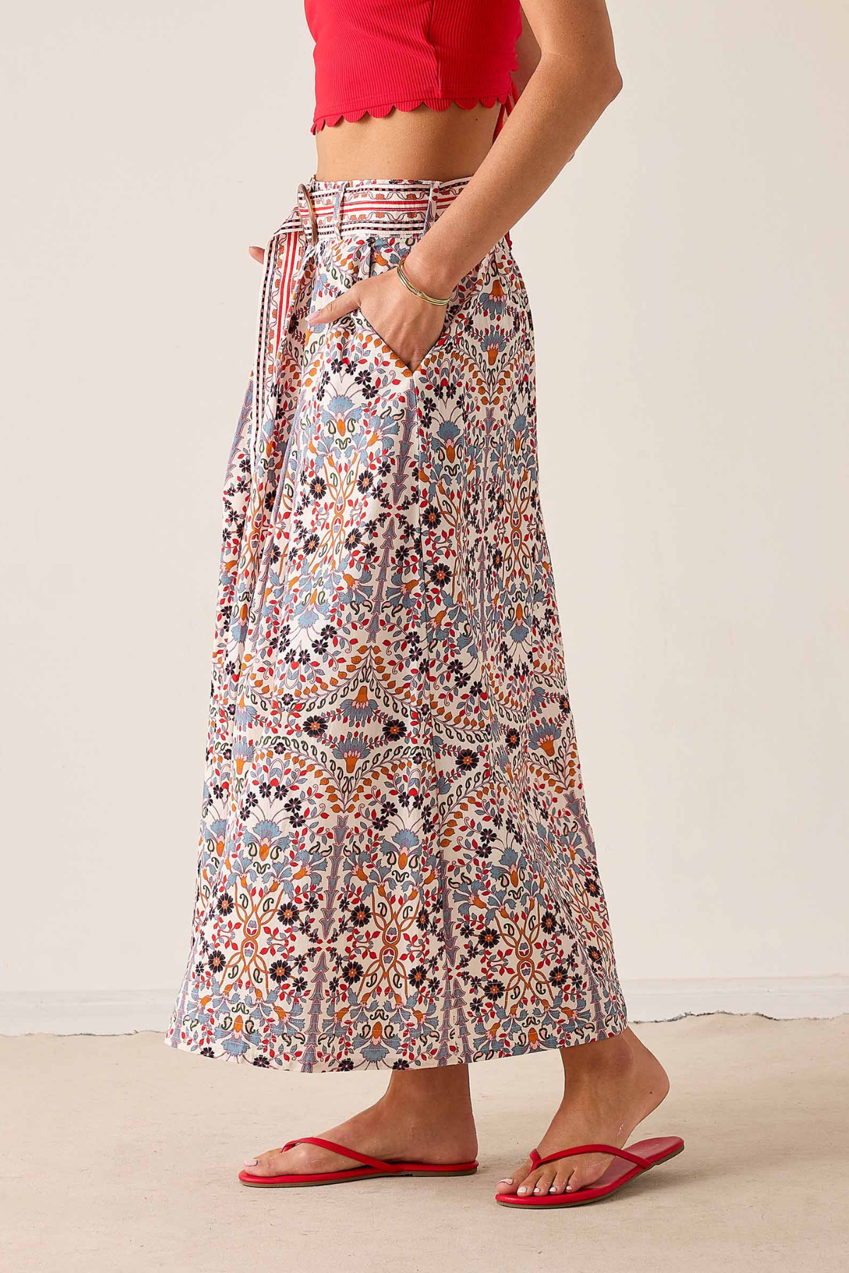 Women's printed midi skirt featuring a flowing silhouette and warm-toned geometric-inspired pattern.