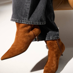 Women's brown textured ankle boot featuring a sleek silhouette and heel.