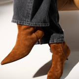 Women's brown textured ankle boot featuring a sleek silhouette and heel.