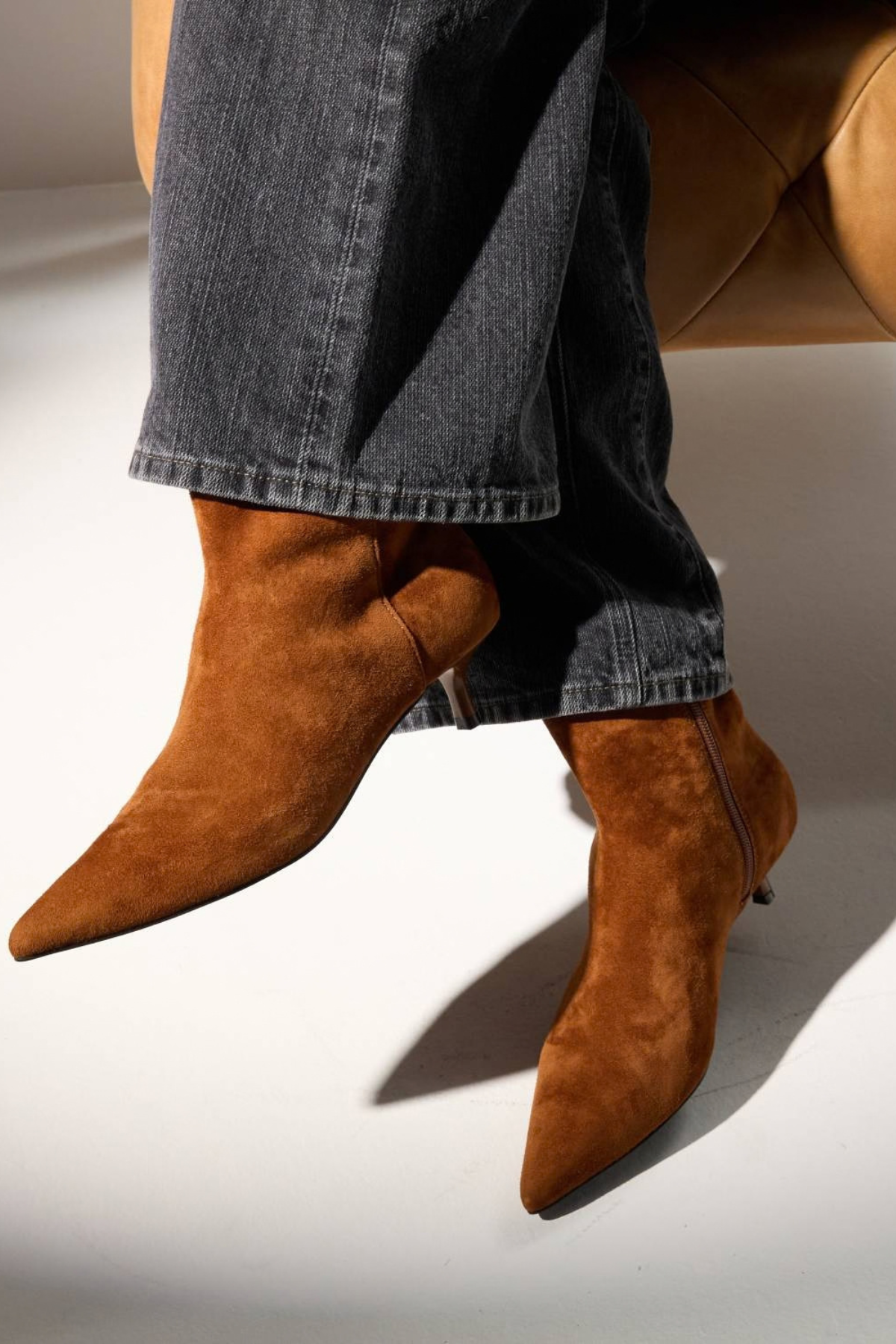 Women's brown textured ankle boot featuring a sleek silhouette and heel.