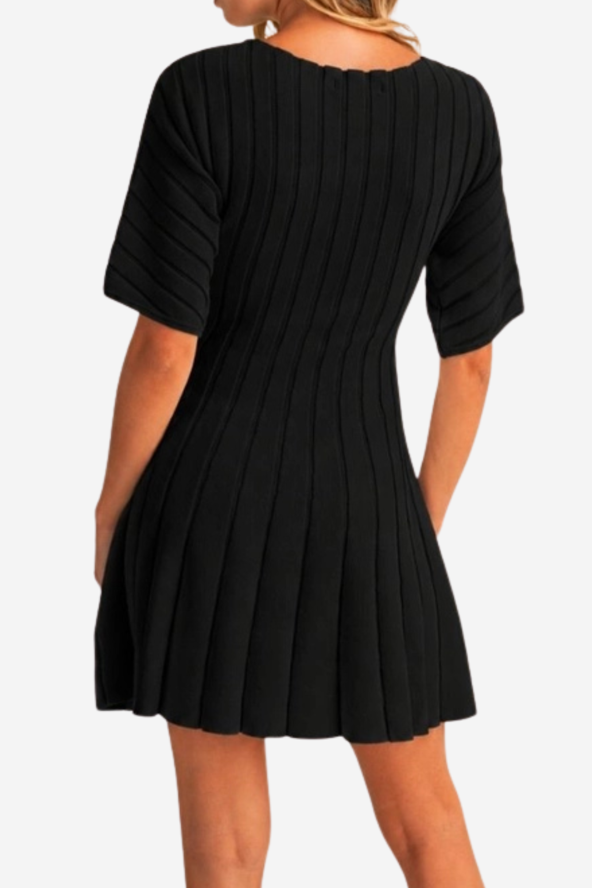 A woman wearing a black short-sleeve ribbed pleated mini dress, shown from the back against a light gray studio background.