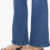 Woman wearing mid-wash flared jeans with a slim fit through the hip and gentle flare at the hem.