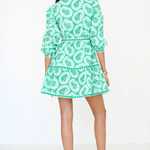 back of woman in green mini dress on white background 