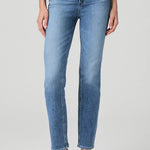 Woman wearing mid-wash straight-leg jeans with a streamlined, classic silhouette.